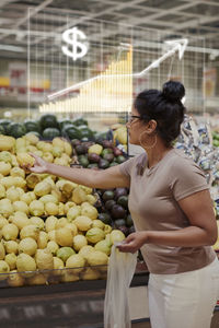 Financial chart and woman shopping in supermarket