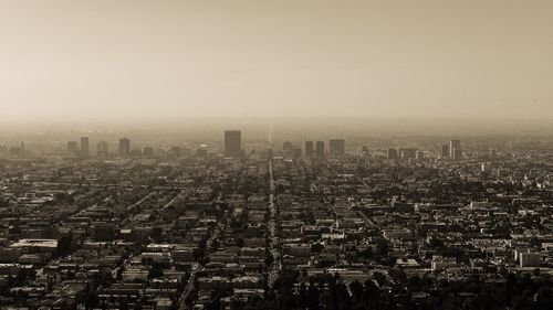 High angle view of city buildings against clear sky