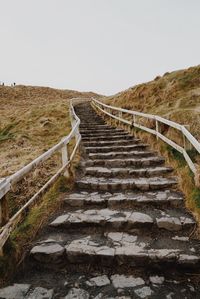 Steps leading towards landscape against sky