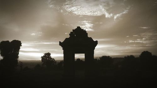 Silhouette of monument against cloudy sky