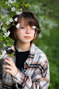 Portrait of young woman sitting on field