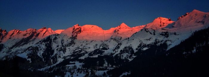 Scenic view of snowcapped mountains against cloudy sky