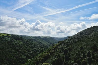 Scenic view of green mountains against sky