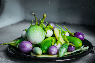 Close-up of eggplants and cucumber in plate