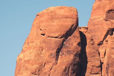 Low angle view of rock formations against sky