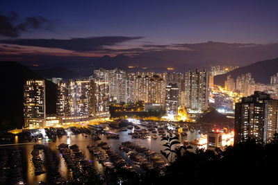 High angle view of illuminated cityscape against sky at night