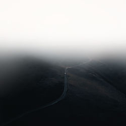 Scenic view of mountains against thick fog