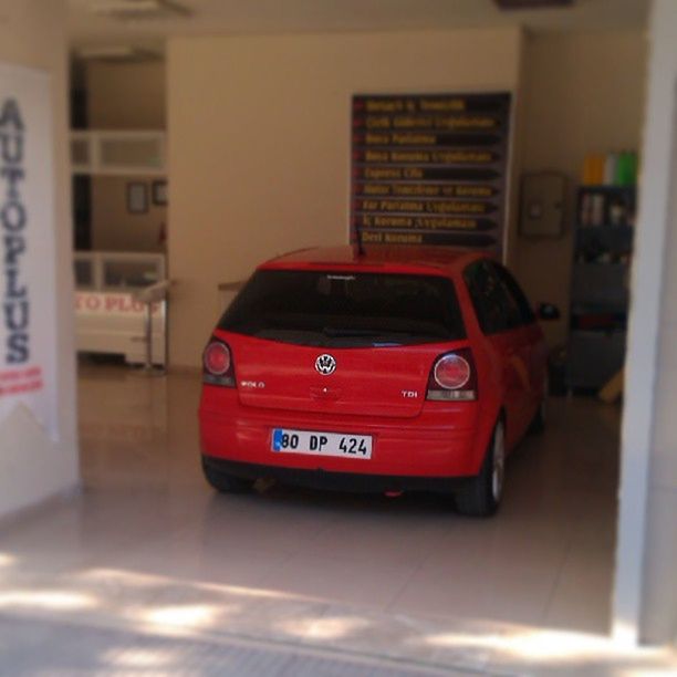 red, indoors, communication, transportation, technology, mode of transport, text, architecture, car, focus on foreground, built structure, land vehicle, no people, close-up, connection, building exterior, western script, day, selective focus, travel