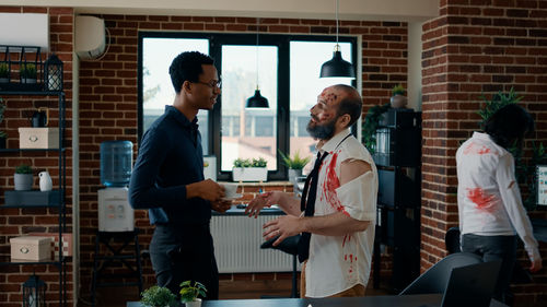 Businessman discussing with colleagues in office