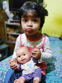 Portrait of cute baby sitting at home