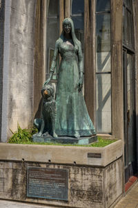 Statue against building