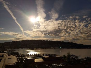 Scenic view of river against sky in city