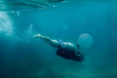 High angle view of man swimming in sea