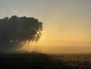 Scenic view of field against sky during sunset