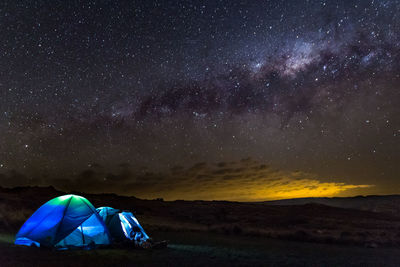 Scenic view of tent against sky at night