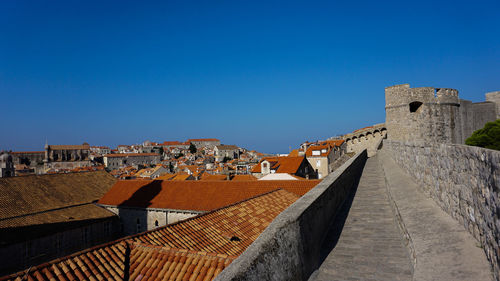 Buildings in city against blue sky