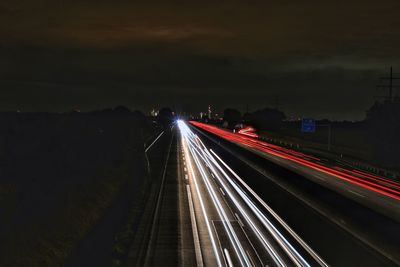 High angle view of light trails on highway at night