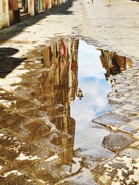 Reflection of buildings in puddle