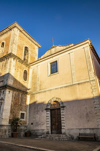 Low angle view of building against clear blue sky