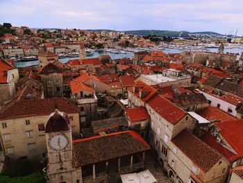 High angle view of houses in town against sky