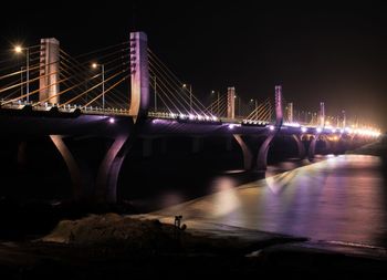 Illuminated suspension bridge at night