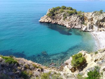 High angle view of rocks on sea shore