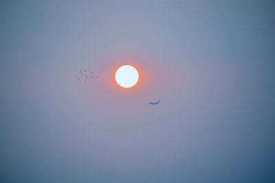 Low angle view of moon against sky during sunset