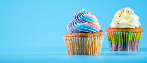 Close-up of cupcakes against blue background
