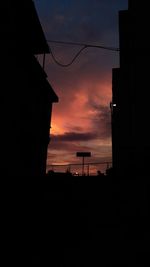 Silhouette buildings against sky during sunset