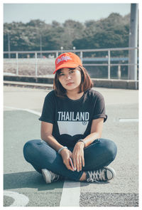 Portrait of young woman sitting outdoors