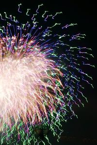 Low angle view of firework display at night