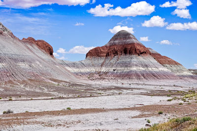 Scenic view of mountain range against cloudy sky