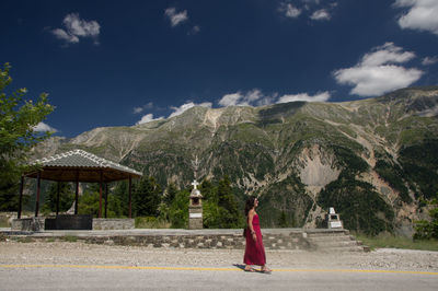 Rear view of a woman walking on road