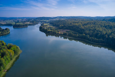 High angle view of river amidst trees against sky