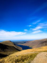 Scenic view of landscape against blue sky