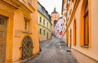 Narrow street amidst buildings in city