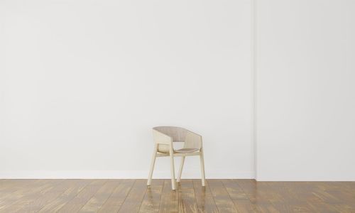 Empty chair against white wall at home