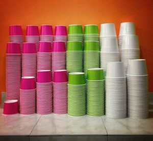 Stack of colorful cups arranged against wall