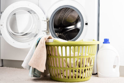 Laundry basket, liquid detergent and washing machine. place to insert