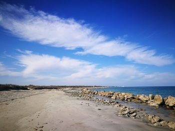 Scenic view of beach against blue sky