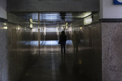 Rear view of man walking in subway