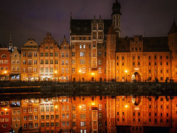 Reflection of illuminated buildings in city at night