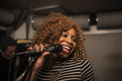 Singer performing in a recording studio