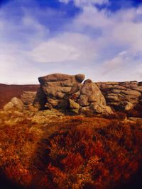 Rock formations on landscape against sky