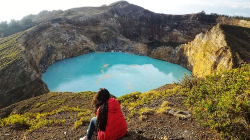 Rear view of woman looking at rocky mountain