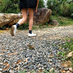 Low section of woman standing on rock