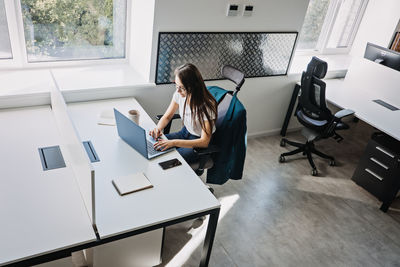 Young female programmer web developer working on computer software in modern office. web designer