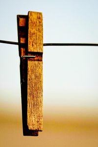 Close-up of metallic structure on table against clear sky