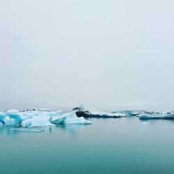 Scenic view of sea against sky during winter