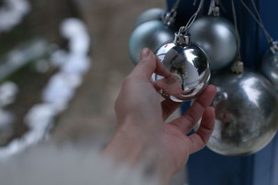  person holding silver bauble